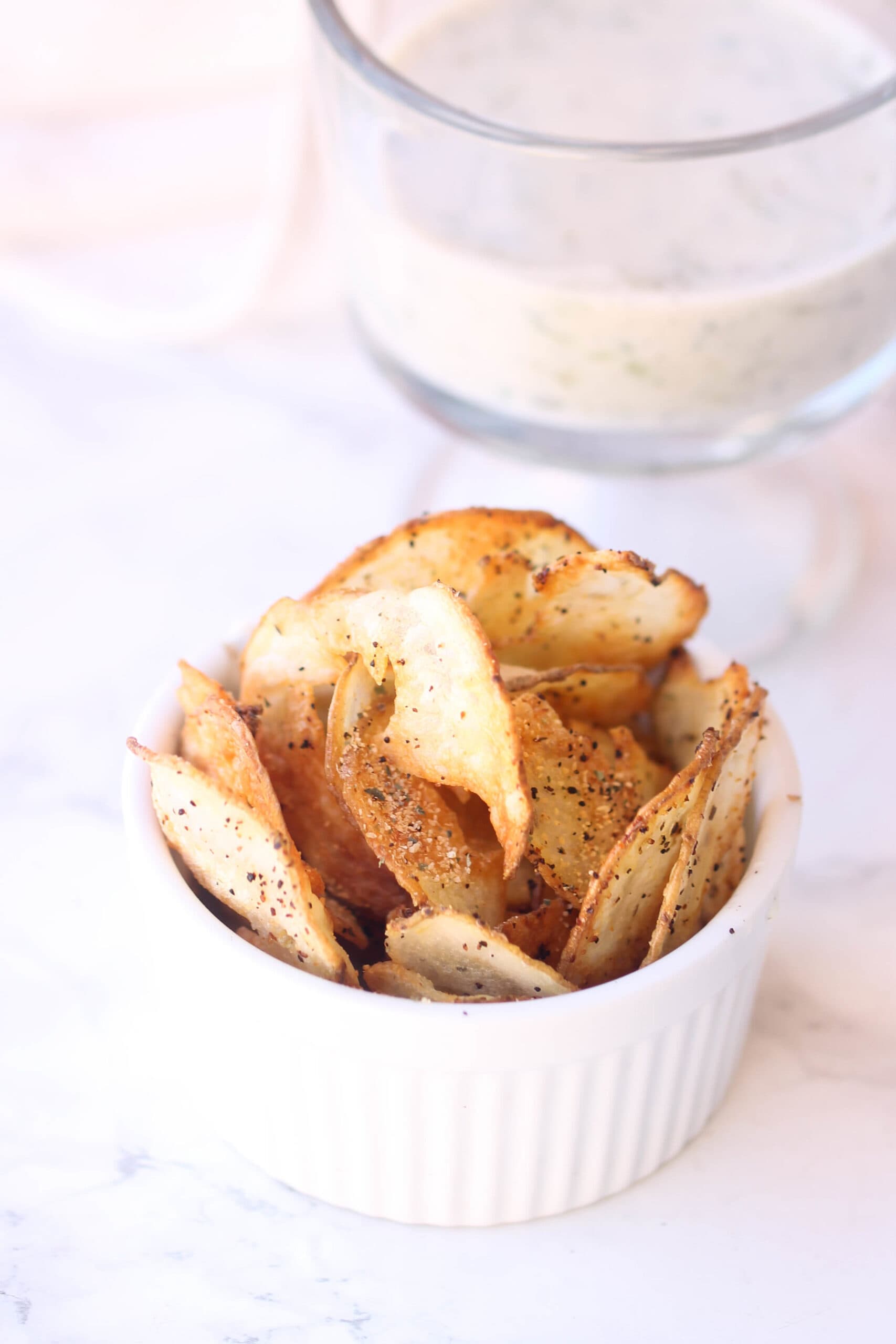 Baked potato chips in a white dish.